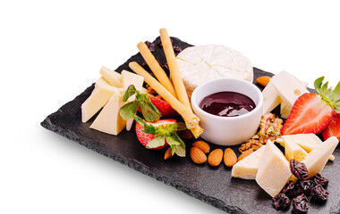 Cheese and fruit platter with jam served on a slate board at a gathering