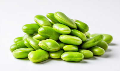 A small pile of green fava beans on a white background