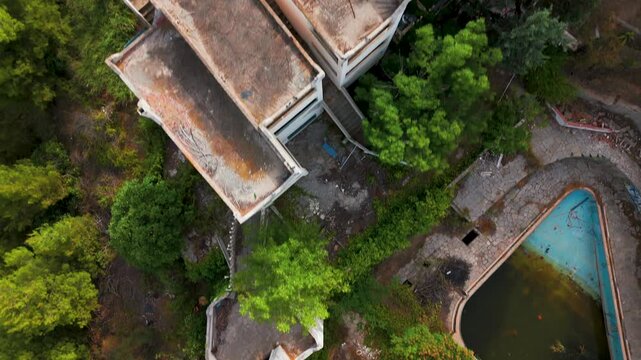 Aerial Drone Top-Down View Of Abandoned Hotel Surrounded By Trees In Kassandra, Halkidiki, Greece.