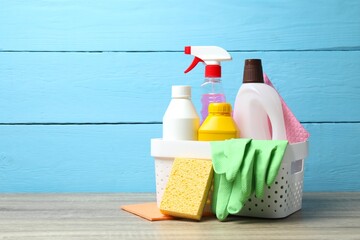 Various cleaning products onThe table. Includes brush, sponge, spray bottle, detergent. Household...