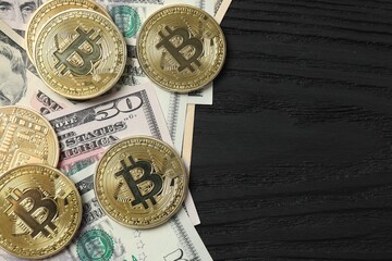 Metal shiny bitcoin crypto currency coins on US dollar bills. Electronic decentralized money concept. 