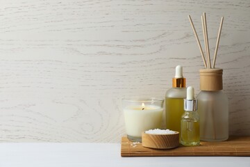 Spa composition with massage oil, candle and aroma diffuser
