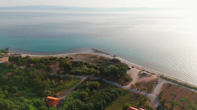 Aerial Drone Reveal Shot of the Aegean Sea and Coast from Afytos, Kassandra, Halkidiki, Greece at Summer Sunrise.
