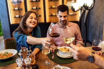 Colleagues Toast with Wine During Lunch at Restaurant