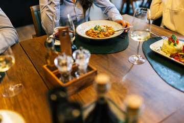 Hands About to Eat Tagliatelle Bolognese in Restaurant