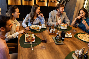 Colleagues Enjoying Lunch with Food and Wine at Restaurant