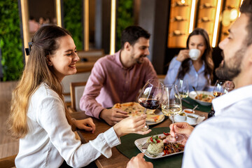 Colleagues Toast with Wine During Lunch at Restaurant