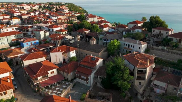 Aerial Drone Shot Circling Low Over Afytos Rooftops, Kassandra, Halkidiki, Greece At Sunrise.