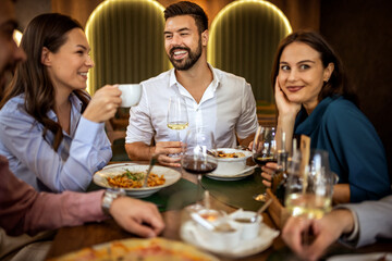 Colleagues Enjoying Lunch with Food and Wine at Restaurant