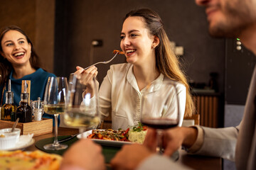 Woman Eating Chicken with Colleagues at Lunch