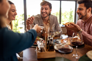 Colleagues Enjoying Lunch with Food and Wine at Restaurant