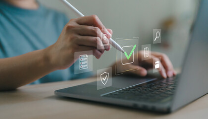 Digital checklist with checkmark on virtual interface. User using stylus and laptop to complete online task approval or document verification in workspace. Certificate planning.