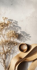 Obraz premium Dried wildflowers and light beige ribbon on a light gray surface.