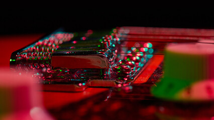 Electric guitar strings and bridge with neon reflections. Concept of live performance, modern sound...