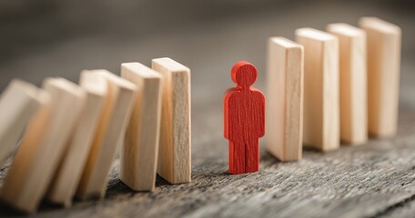 A red figure stands before falling dominoes, symbolizing resilience & choice