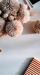 Delicate dried flower arrangement on a light background.