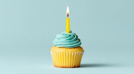 Cupcake with Blue Frosting and a Single Lit Candle on a Solid Background
