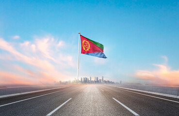 Eritrea national flag with mast waving with beautiful skyline. A view from highway. Eritrea flag...