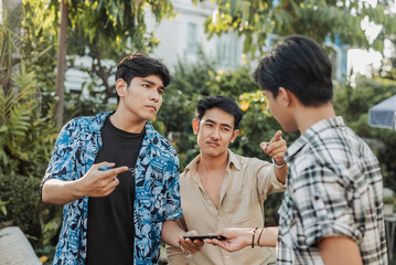 An anxious young Asian man is coerced into handing over his phone to two bullies who confront him...