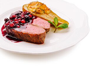 Delicious gourmet dish featuring roasted meat and berry sauce served elegantly