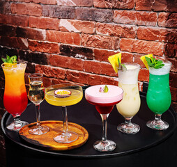 Colorful cocktails arranged on a table in a lively bar setting