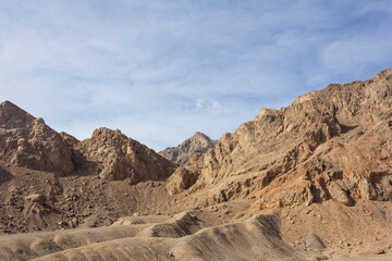 Rugged desert mountains under a vivid blue sky near Yazd, Iran—showcasing dramatic geology, arid terrain, and timeless natural beauty