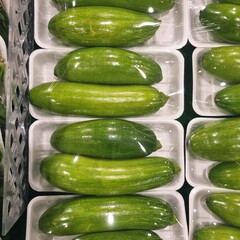 The images show a market display of fresh, individually-packaged Korean zucchini, also known as 'aaehobak'. These are commonly used in various Korean dishes.