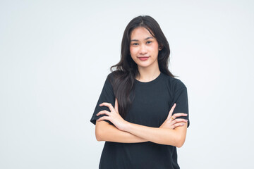 A strong young Asian woman posing with her arm folded, giving a fierce and smug smirk while locking eyes with the camera. Isolated on a white background.