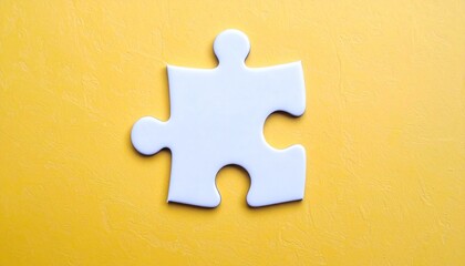 Obraz premium A single white jigsaw puzzle piece with two knobs and two holes lies against a bright yellow background. Its classic shape and bold contrast evoke problem-solving, clarity, and connection.
