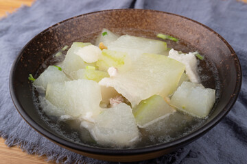 Winter melon and pork soup in a porcelain bowl