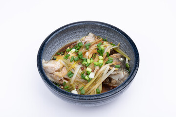Steamed sea bass in a porcelain bowl
