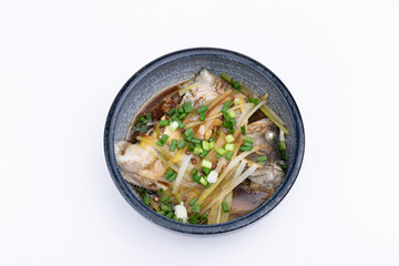 Steamed sea bass in a porcelain bowl