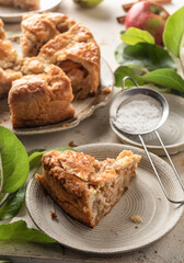 Slice of homemade Apple Pie with fresh apples on textured background. Thanksgiving traditional dessert, autumn baking, recipe
