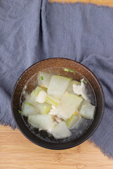 Winter melon and pork soup in a porcelain bowl
