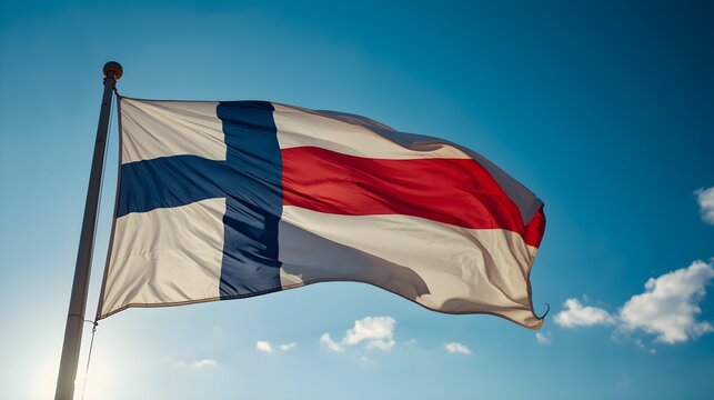 The national flag of finland a white and blue nordic cross design proudly waves in the bright sunlight against a clear blue sky with scattered white clouds