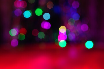 Blurred abstract Christmas background. Bokeh. Toys and glowing illumination. Red shade.