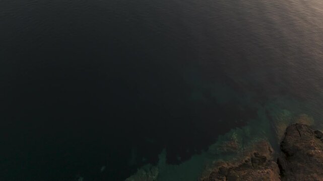 Top Down Aerial Drone Shot Of The Coastline And Aegean Sea In Paliouri, Kassandra, Halkidiki, Greece At Dawn On A Hazy Morning.
