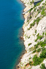 Coastal waters meet rocky hillside