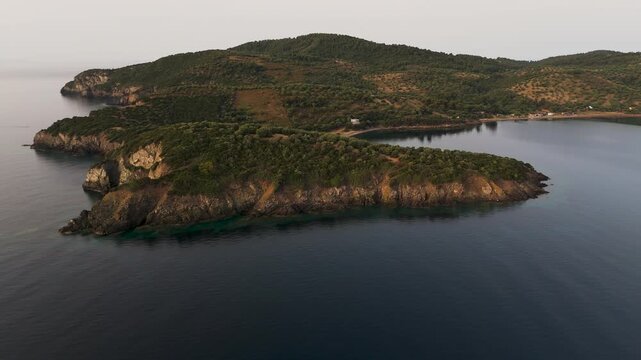 Circling Aerial Drone Shot Over The Aegean Sea Coastline In Paliouri, Kassandra, Halkidiki, Greece At Sunrise.