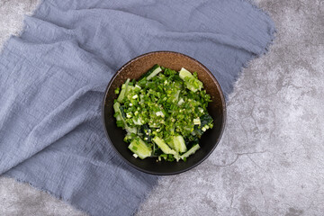A smashed cucumber in a porcelain bowl