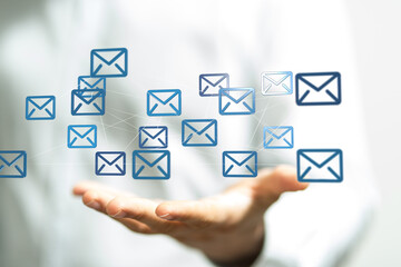Hand holding network of email icons.  Digital communication, global network, and email marketing concept.