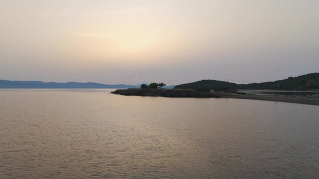 Low Altitude Aerial Drone Shot Over Calm Aegean Sea Off Kassandra Coast, Halkidiki, Greece At Sunrise.