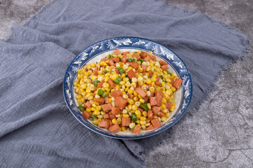 The sausage stir-fried with corn kernels on the plate
