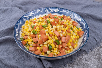 The sausage stir-fried with corn kernels on the plate