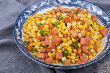 The sausage stir-fried with corn kernels on the plate