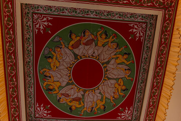  Handmade colorful painting at the canvas on plain wall. Interior decoration concept.