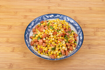The sausage stir-fried with corn kernels on the plate