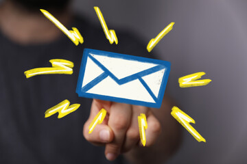 Hand clicking email icon, symbolizing online communication and messaging.