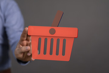 Hand holding a 3D shopping cart icon.  Perfect for e-commerce, online retail, and digital marketing.