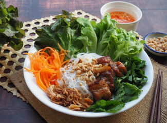 Bun Thit Nuong - Vietnamese grilled pork on vermicelli and vegetables top with peanuts at close up view